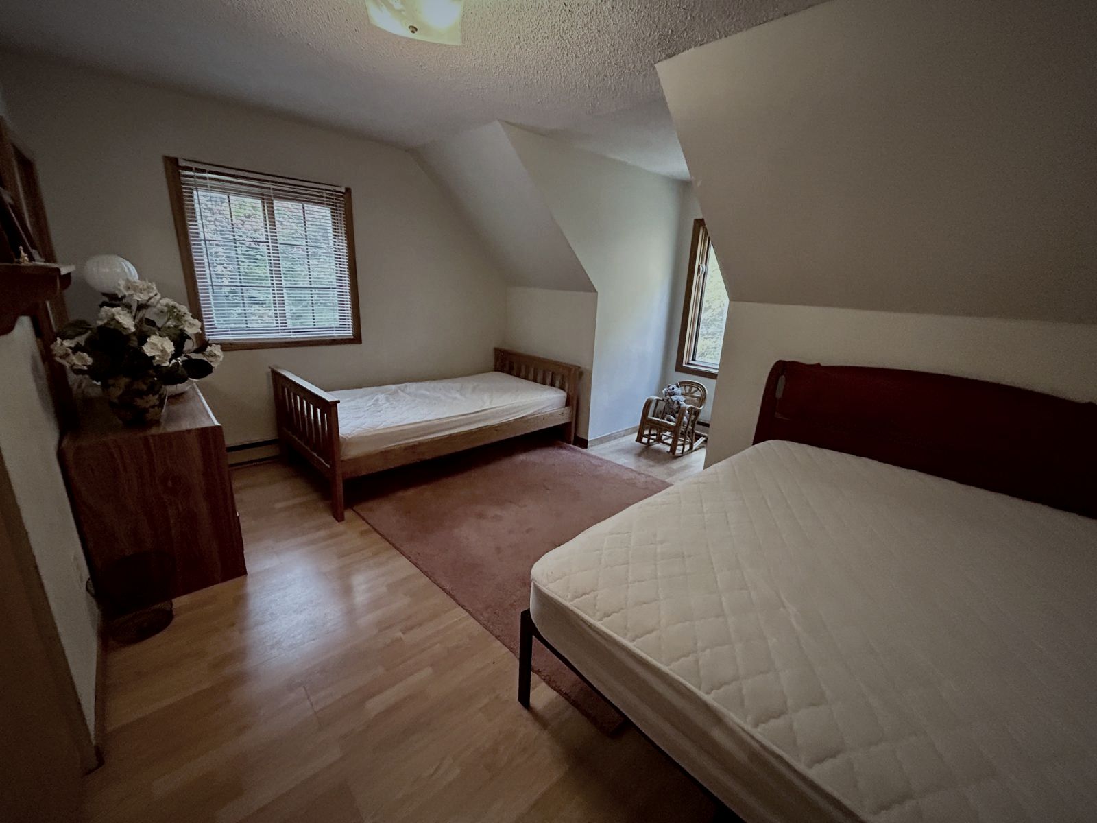 Bedroom with two beds under the eaves