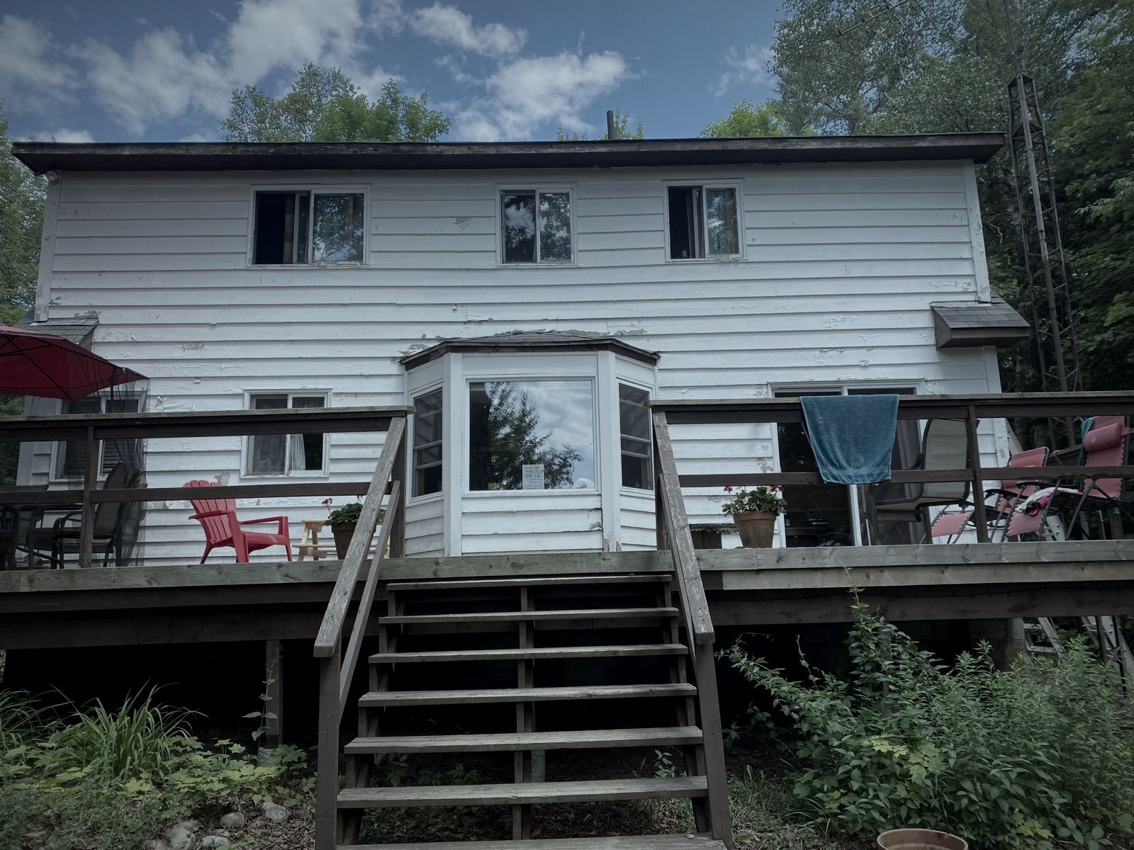 The back of the cabin with a raised deck and stairs